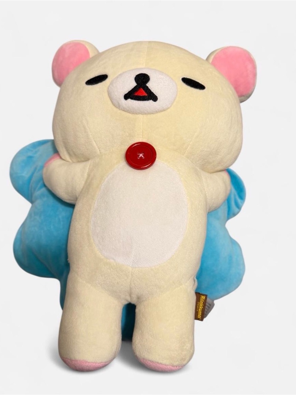 Rilakkuma plush on blue pillow Bear Anime